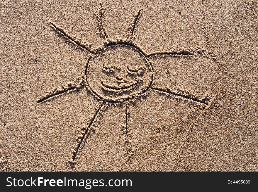 Smiling sketch of a sun drawn on the sand. Smiling sketch of a sun drawn on the sand