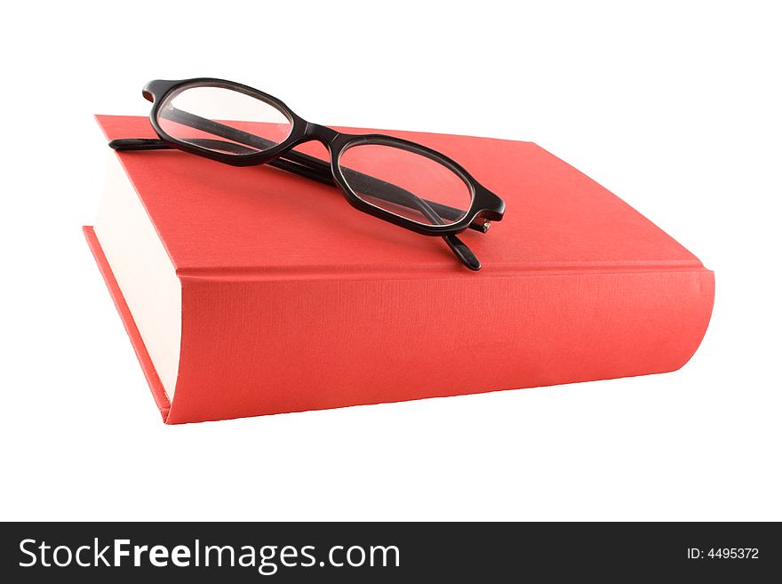 Red book and black glasses on a white background