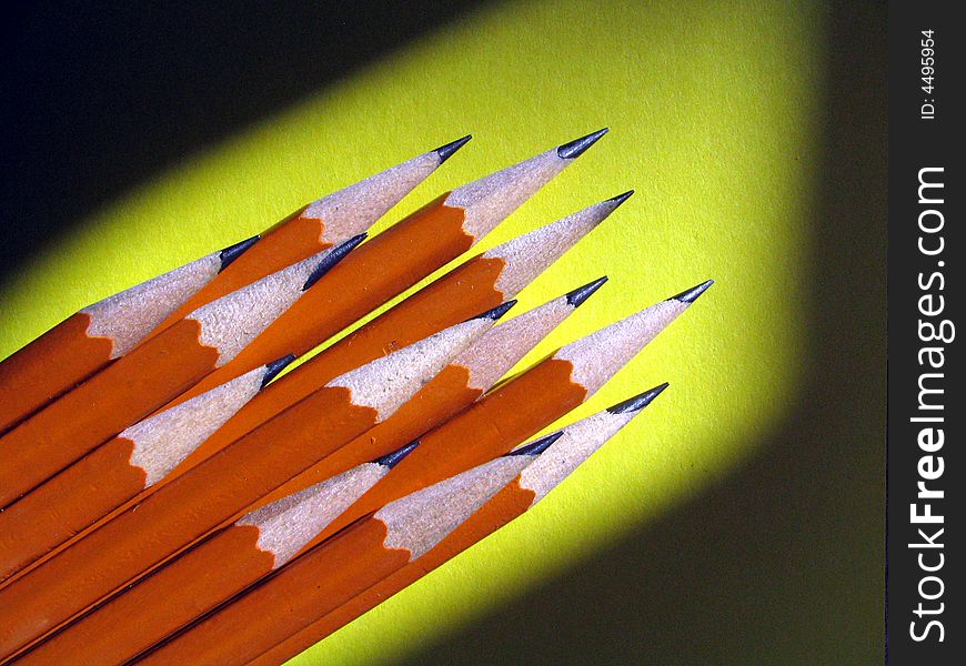 Sharpened pencils against yellow background. Sharpened pencils against yellow background.