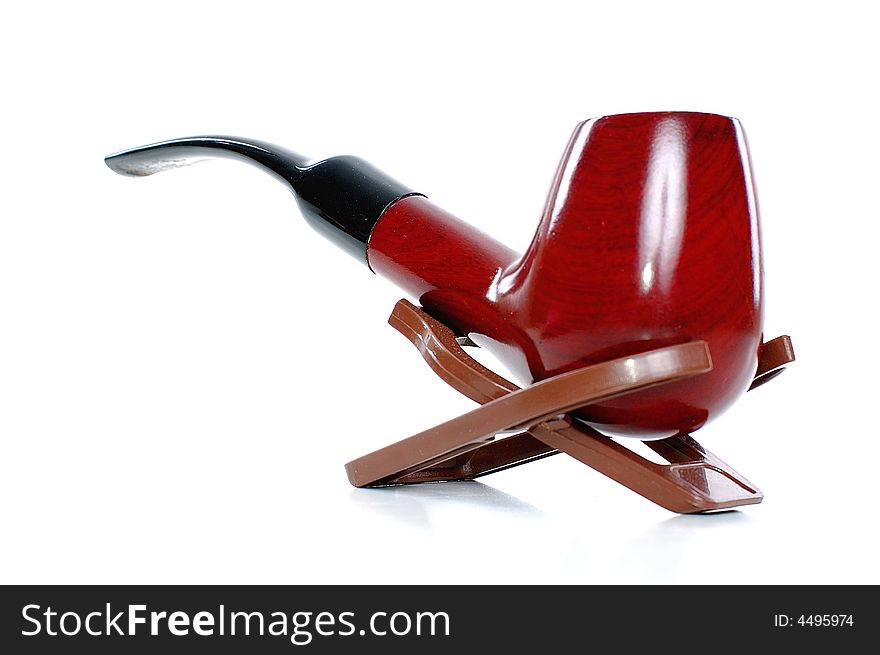 Classic tobacco-pipe in a holder, close up, isolated on white