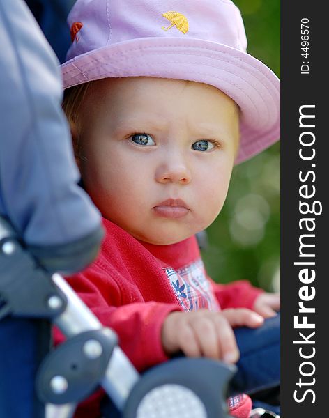 Child sitting in a pram. Child sitting in a pram