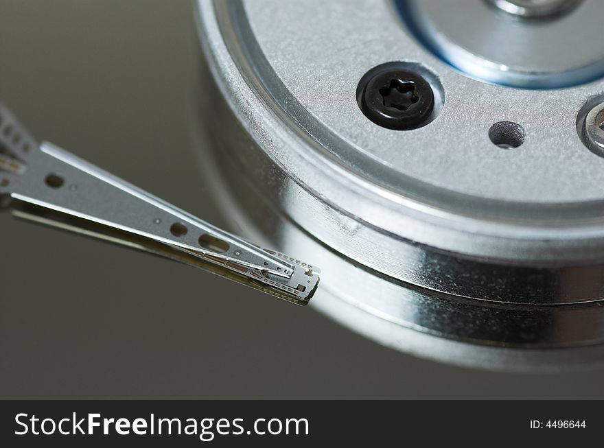 Close-up of hard disk head over a plate. Close-up of hard disk head over a plate