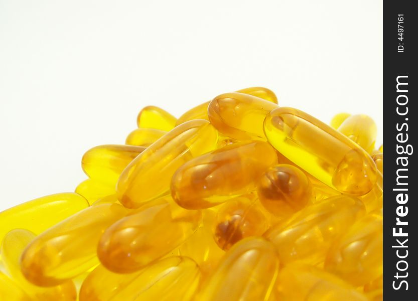 Image of flax seed oil capsules piled together, with white background. Image of flax seed oil capsules piled together, with white background.