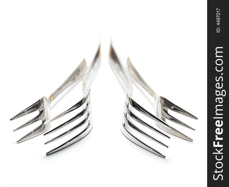 Four forks isolated on white. High key. Handle is out of focus