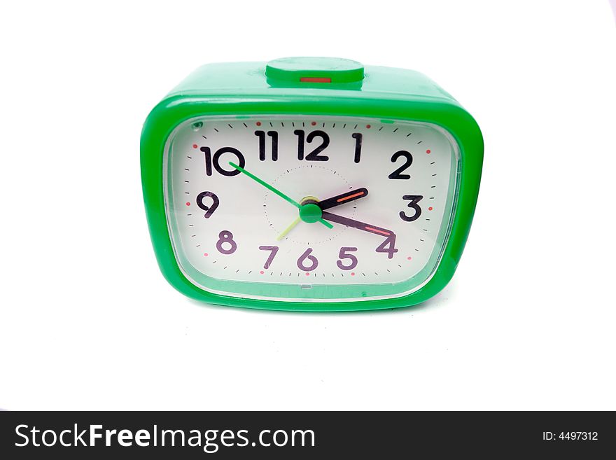 Green alarm clock on a white background