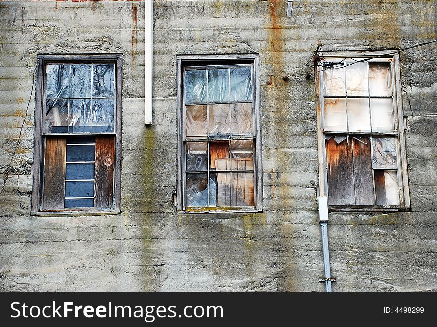 Decrepit and cluttered windows on old warehouse. Decrepit and cluttered windows on old warehouse