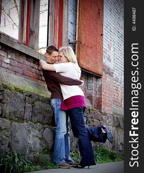 Young couple hugging in an industrial part of the city