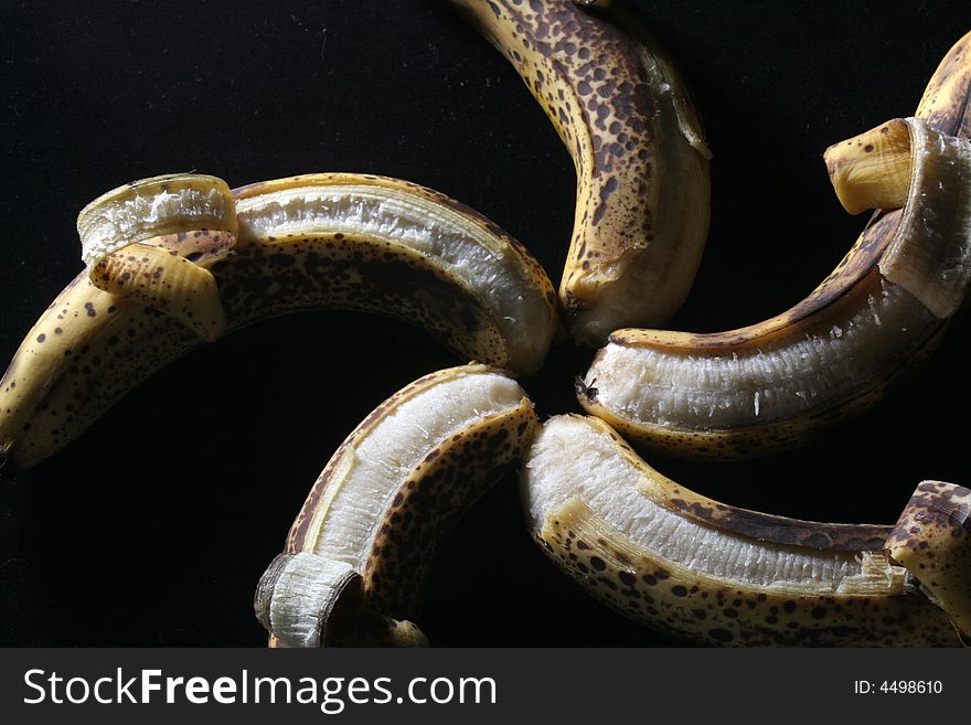 Five bananas in a star pattern isolated against a black background. Five bananas in a star pattern isolated against a black background