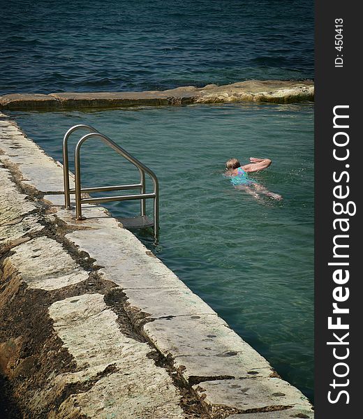 Swimmer in an ocean pool