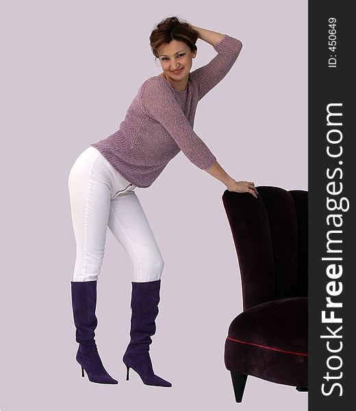Woman standing by a purple chair. Woman standing by a purple chair