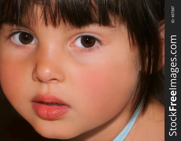 Face of a little girl with rosebud shaped lips and large brown eyes. Face of a little girl with rosebud shaped lips and large brown eyes.