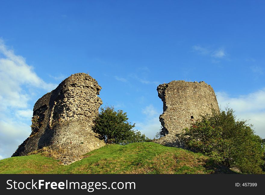 Derelict remains of the ancient Llandovery castle, Wales, United Kingdom, built in 1116 AD. Set against a blue sky. Derelict remains of the ancient Llandovery castle, Wales, United Kingdom, built in 1116 AD. Set against a blue sky.