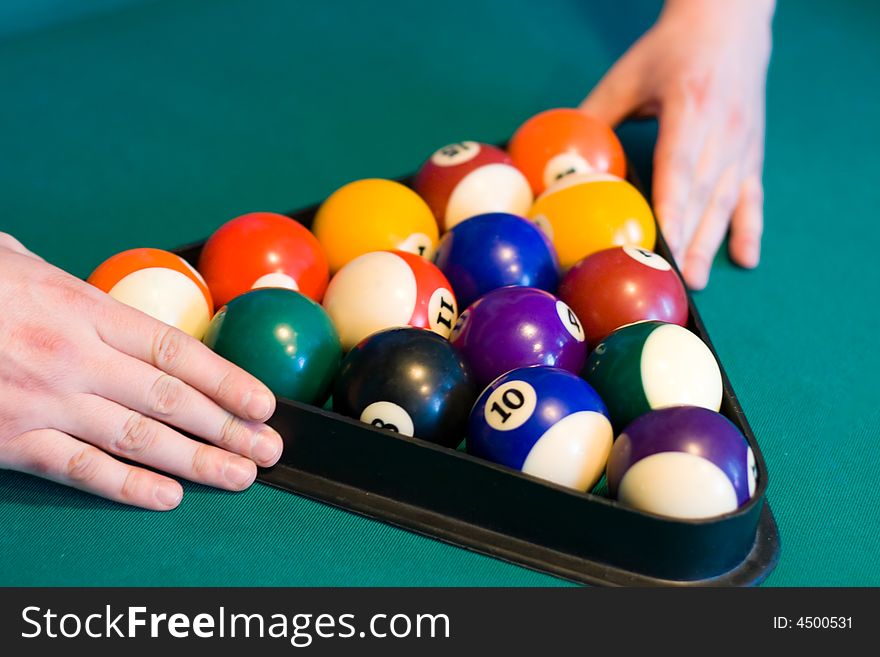 Color billiards balls with man hands