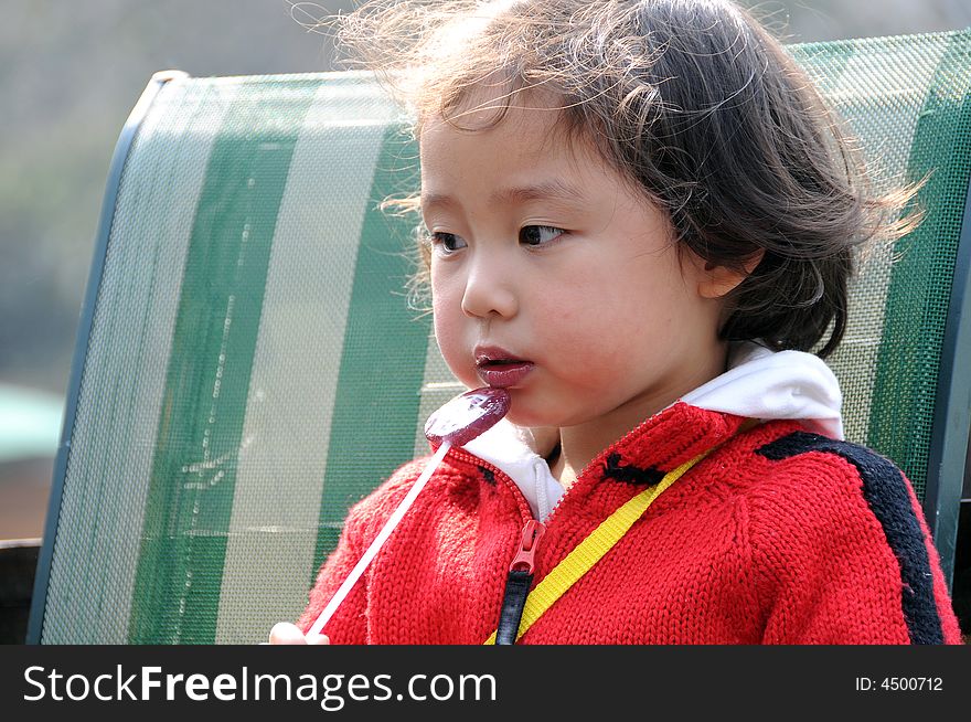 A beautiful girl in redï¼Œand eat the sugar. A beautiful girl in redï¼Œand eat the sugar