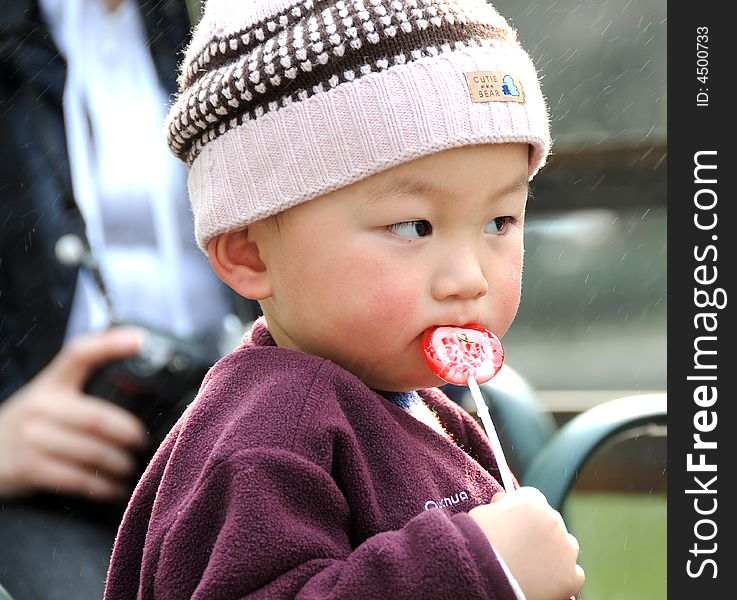 A lovely baby enjoys his sweet lollipop. A lovely baby enjoys his sweet lollipop.