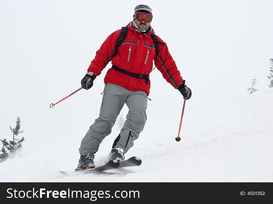 Alpine skier close-up in the move on mountain resort