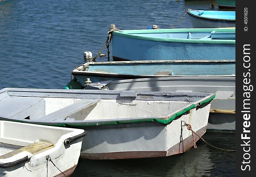 Row boats sitting in the Mediterranean ocean. Row boats sitting in the Mediterranean ocean