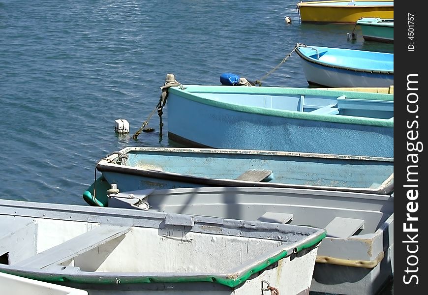Row boats sitting in the Mediterranean ocean