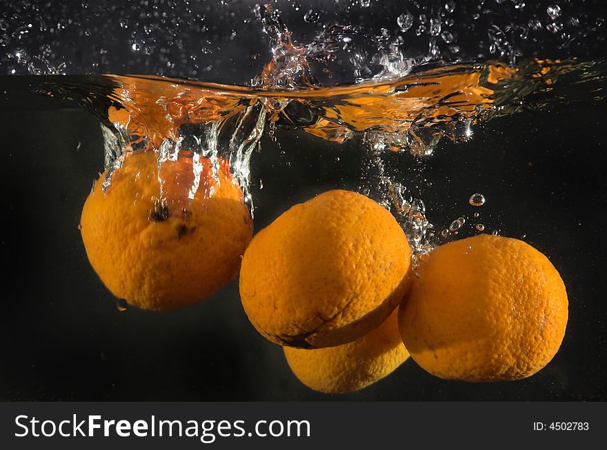 Tangerines Falling In Water
