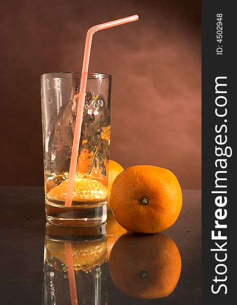 Glass of a drink with a tangerine,food