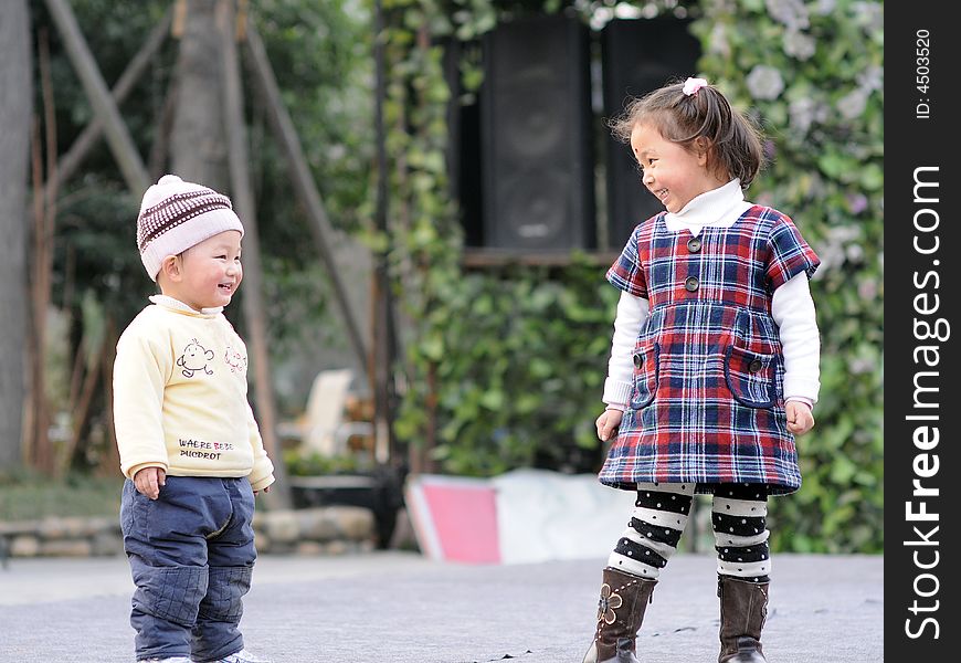 Little boy and little girl watchs each other. Little boy and little girl watchs each other.