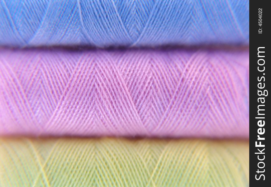 Macro photograph of sewing thread on spool