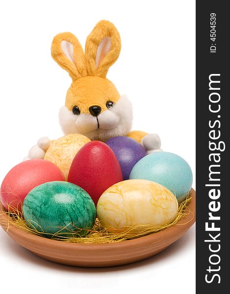 Easter colored eggs on a plate with rabbit. Easter colored eggs on a plate with rabbit.