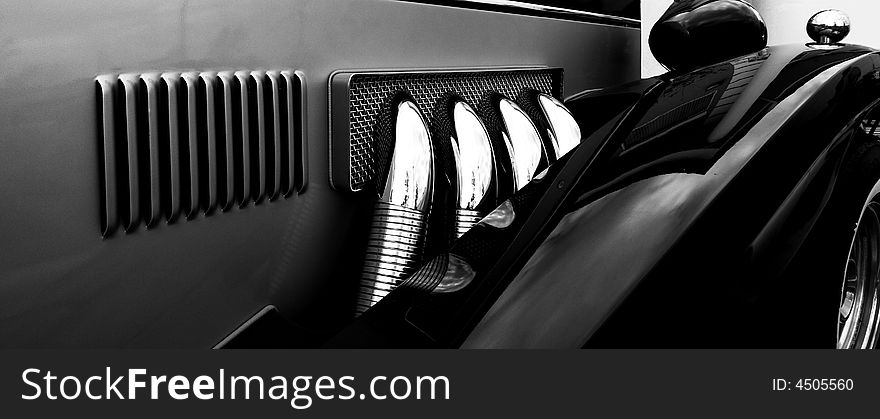 Exhaust of a Clenet Roadster Series 3 in black and white