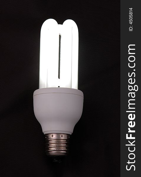 Compact fluorescent light with dark back ground. Compact fluorescent light with dark back ground