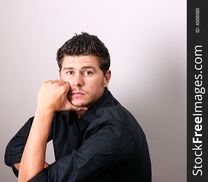 Male model in studio against white wall. Male model in studio against white wall