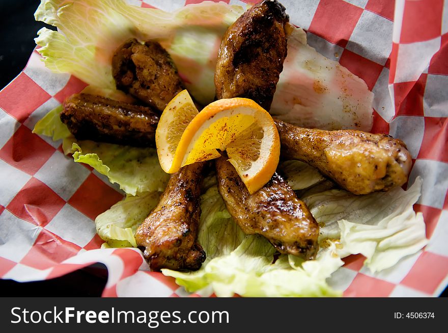 Image of baked chicken wings topped with lemon slice