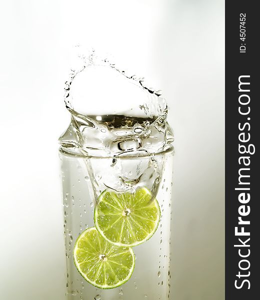 Lime slices in a glass of water. Lime slices in a glass of water