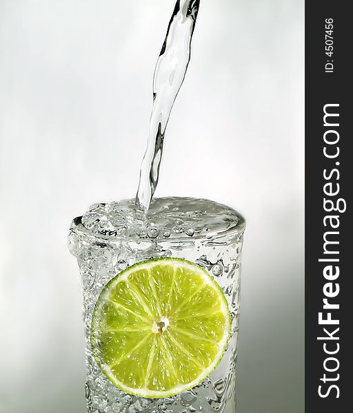 Lime slice in a glass of water. Lime slice in a glass of water