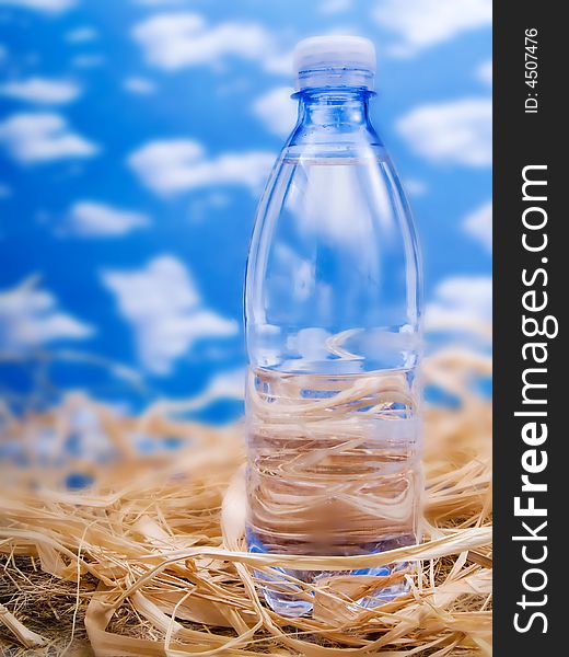 Bottle of mineral water over a blue sky. Bottle of mineral water over a blue sky