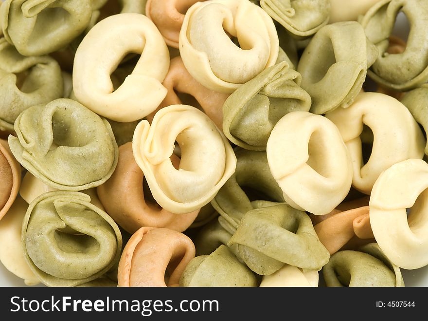 Close-up of tortellini tricolore pasta for backgrounds