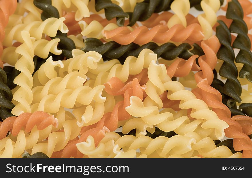 Close-up of fusilli tricolore pasta for backgrounds. Close-up of fusilli tricolore pasta for backgrounds