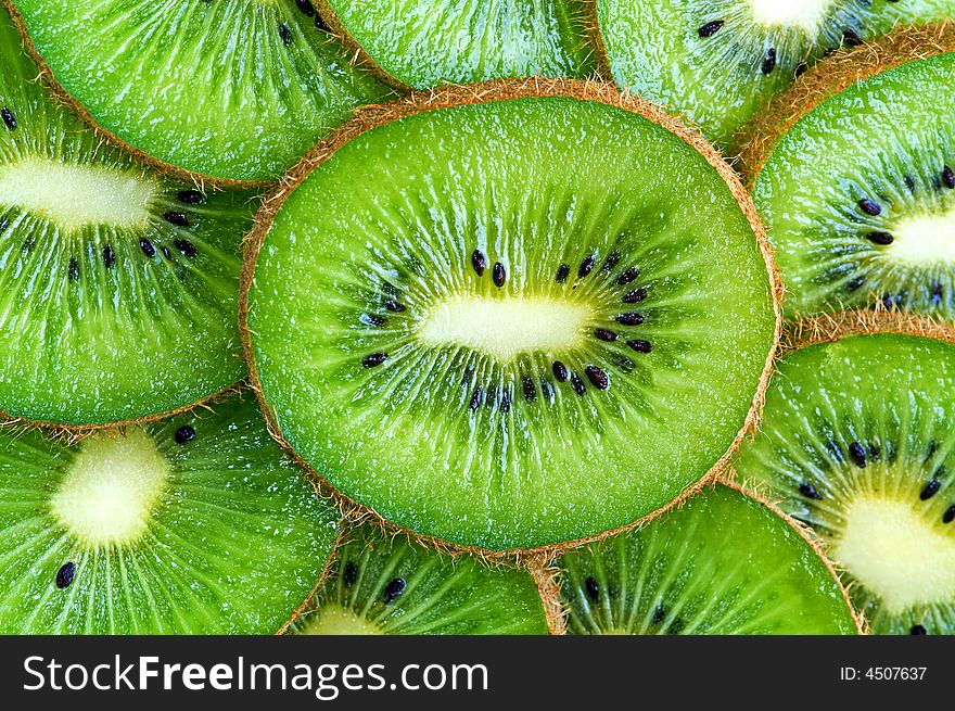 Ripe green kiwi slices background