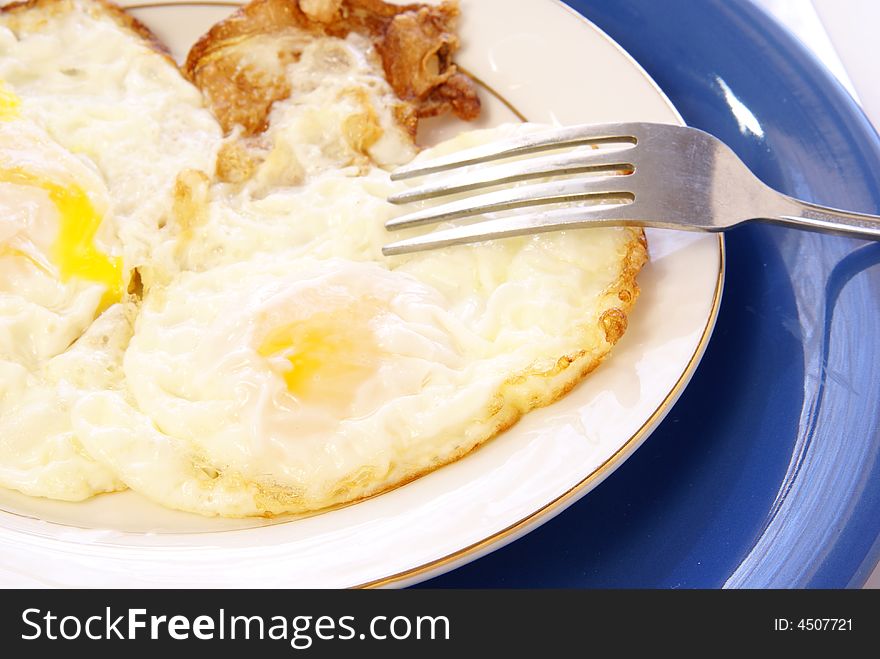 Fried Eggs on white and blue table setting