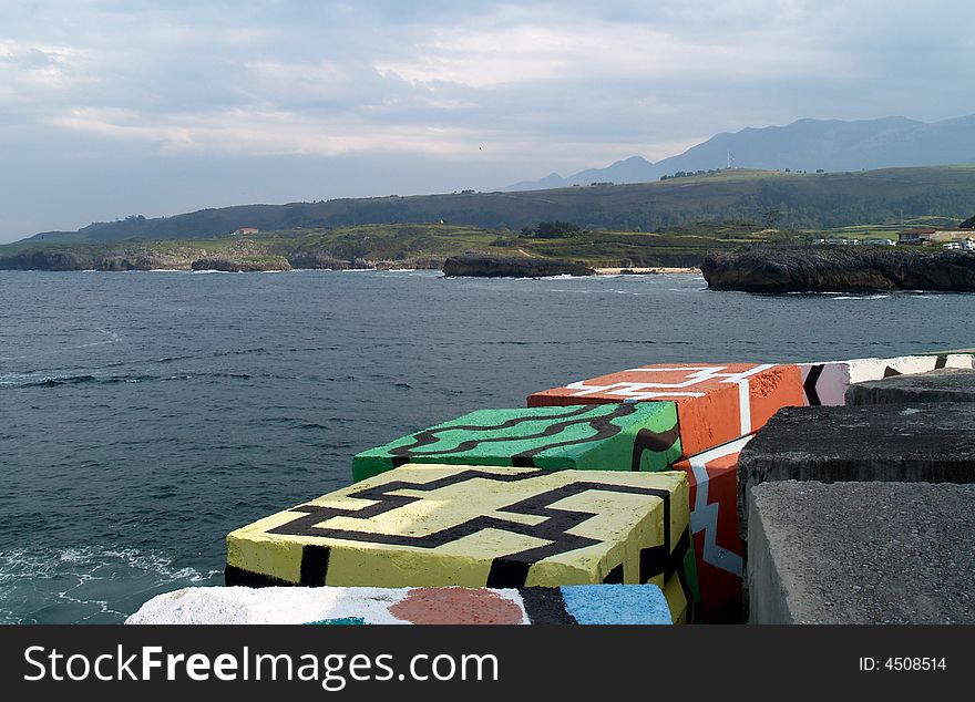 Concrete coloured cubes in Llanes port. Concrete coloured cubes in Llanes port