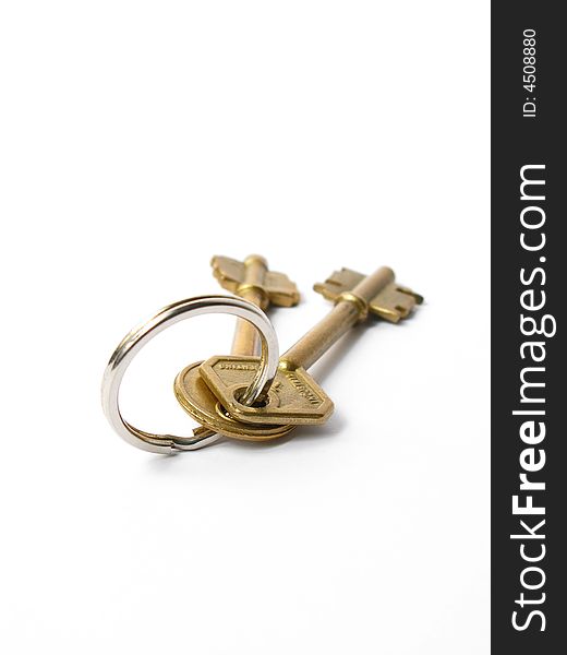 Two isolated gold keys joined by silver ring
