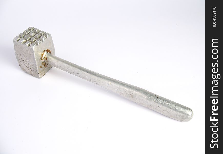 Old metalic meat hammer in white background