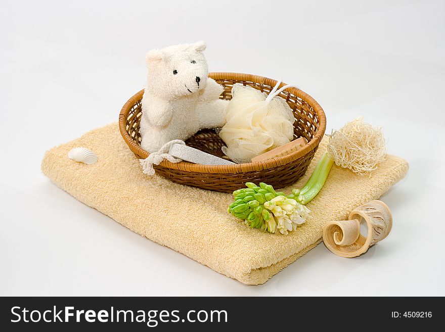 Basket with bath items, a towel and a flower. Basket with bath items, a towel and a flower.