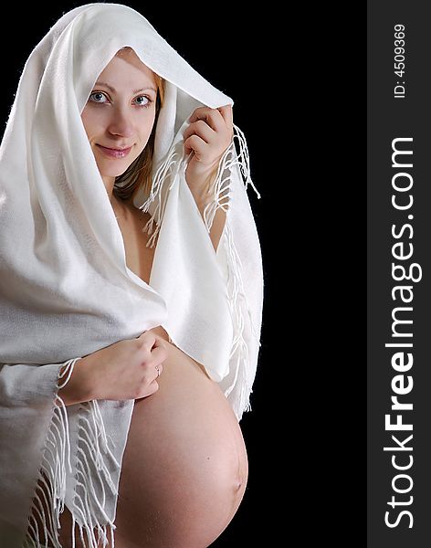 Beautiful pregnant woman isolated on black