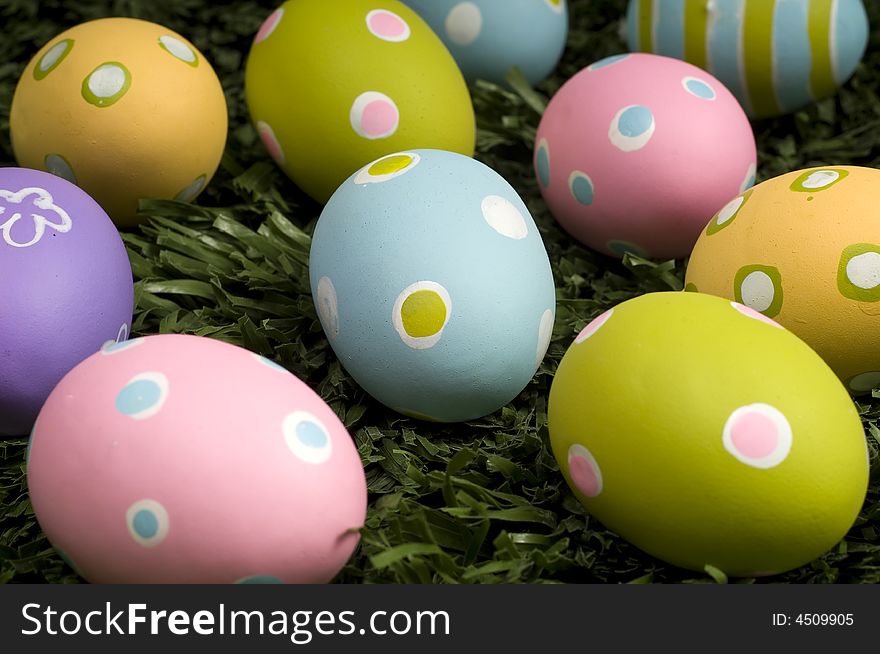 A group of brightly colored easter eggs on green grass. A group of brightly colored easter eggs on green grass