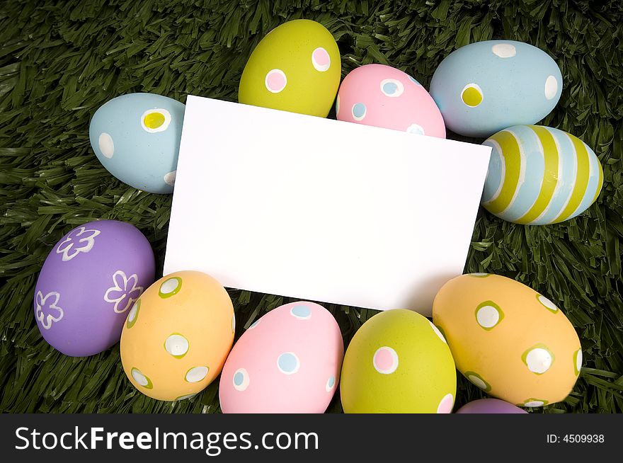 A white notecard surrounded by brightly colored Easter eggs, insert message or design. A white notecard surrounded by brightly colored Easter eggs, insert message or design