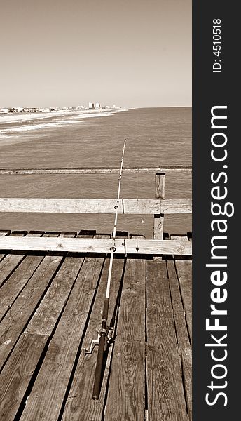 One single fishing pole on pier. In sepia. One single fishing pole on pier. In sepia.