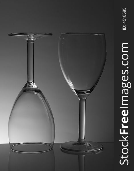 Two white wine glasses on gradiented background. Two white wine glasses on gradiented background