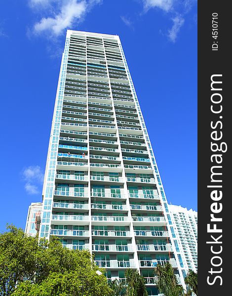 Modern abstract condominium building on a blue sky. Modern abstract condominium building on a blue sky