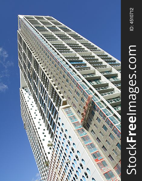 Modern abstract condominium building on a blue sky. Modern abstract condominium building on a blue sky