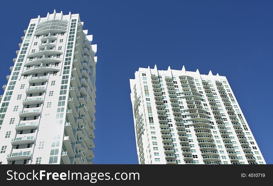 Modern abstract condominium building on a blue sky. Modern abstract condominium building on a blue sky